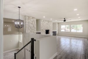 A living room with hard wood floors and white walls.