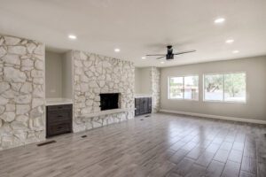 A living room with a fireplace and tile floors.