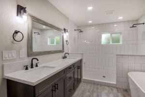 A bathroom with two sinks and a large mirror.