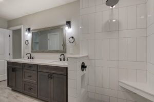 A bathroom with two sinks and a mirror.