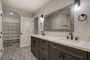 A bathroom with two sinks and a large mirror.