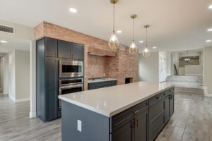 A kitchen with an island and brick walls