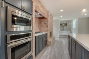 A kitchen with an oven and sink in it