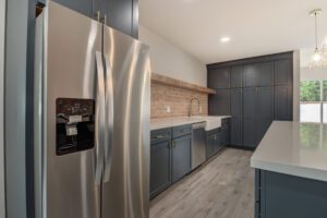 A kitchen with stainless steel appliances and wooden cabinets.