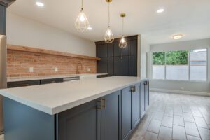 A kitchen with a large counter and some lights