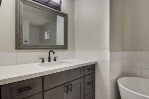 A bathroom with a sink, mirror and toilet.