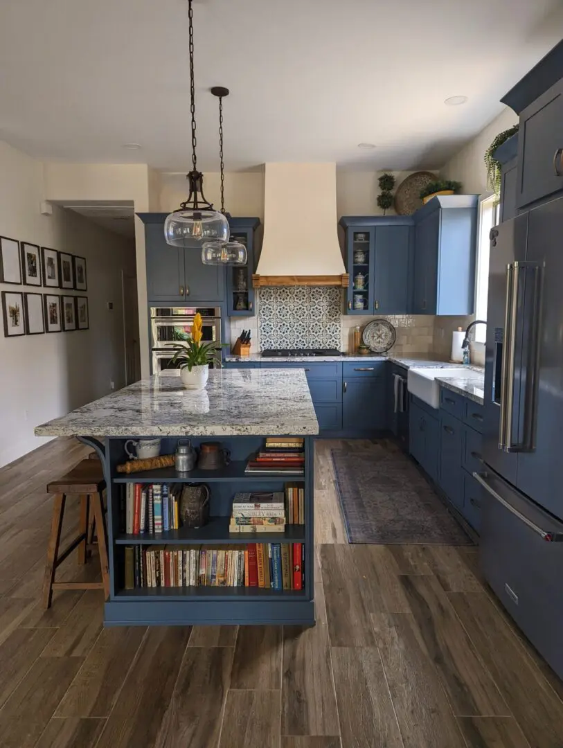 Builders Flooring & Design project gallery cabinets. Custom color kitchen cabinets in blue and wood look floor tile.