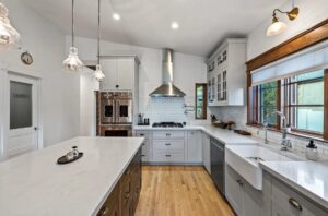 a inset kitchen with gray perimeter and wood island