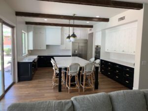 a inset kitchen with black lowers and white uppers