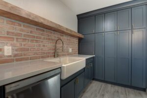 blue shaker kitchen cabinets with wood look tile floor