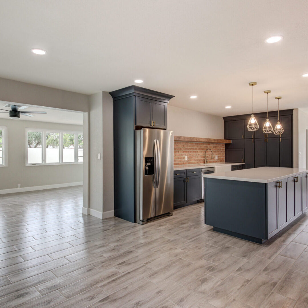 blue shaker kitchen cabinets with wood look tile floor