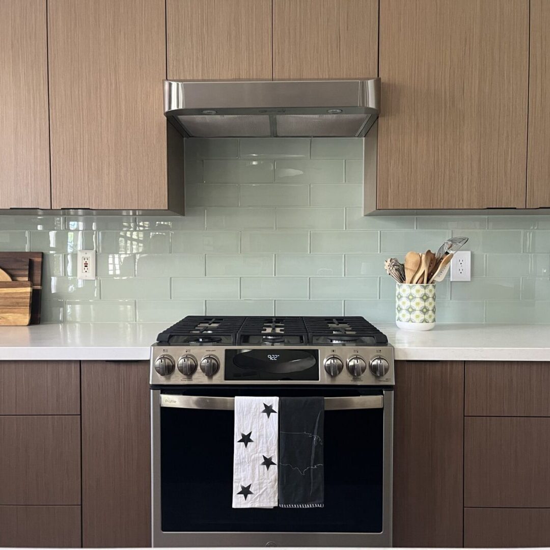 A kitchen with a stove and cabinets in it