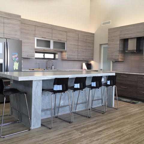 A kitchen with a large island and lots of counter space.