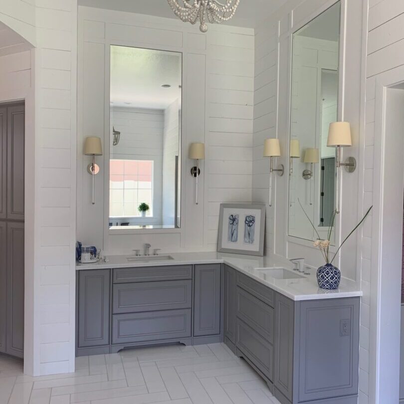 A bathroom with two sinks and a large mirror.