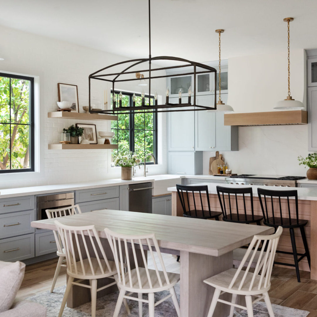 A kitchen with white walls and wooden floors.