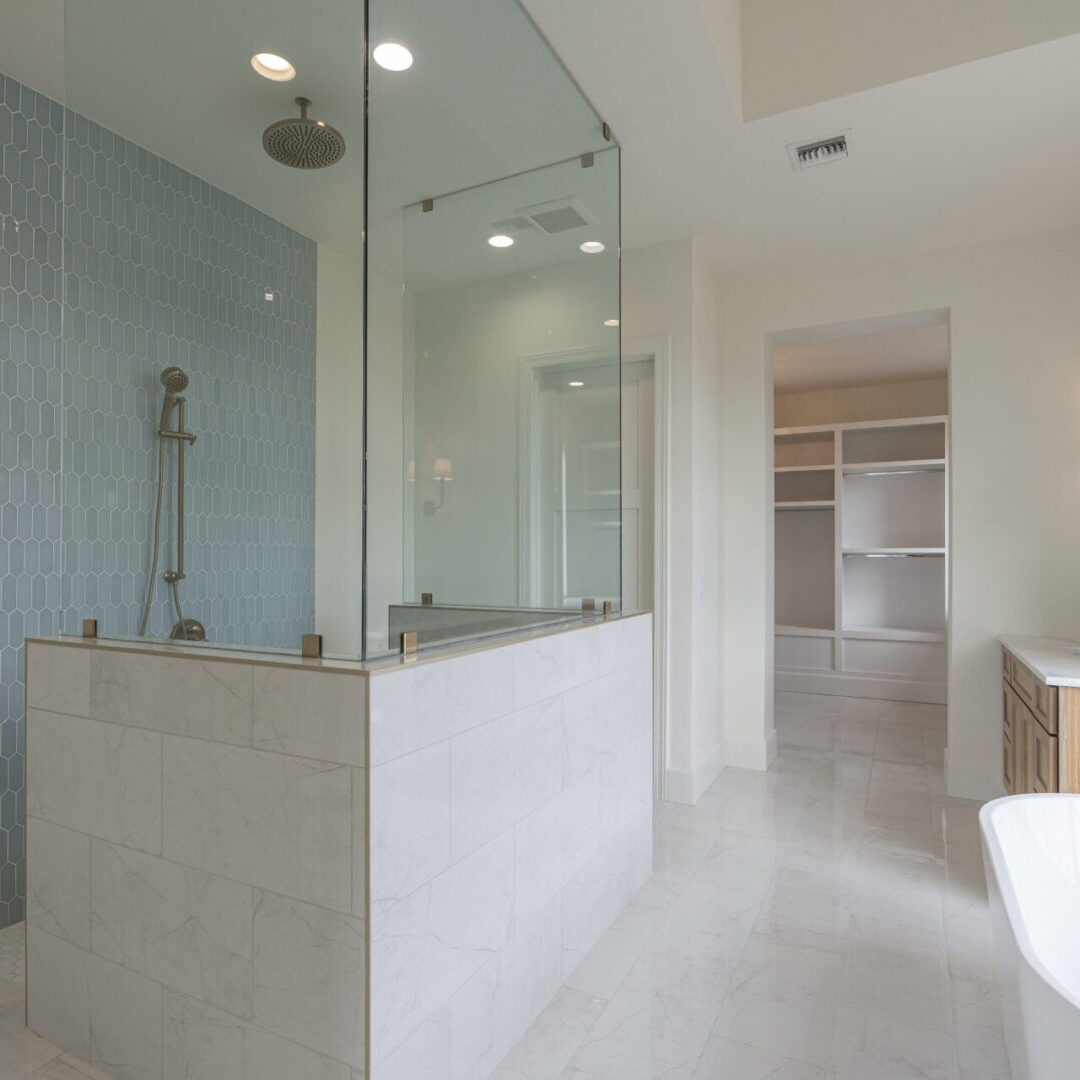 A bathroom with a walk in shower and tiled walls.