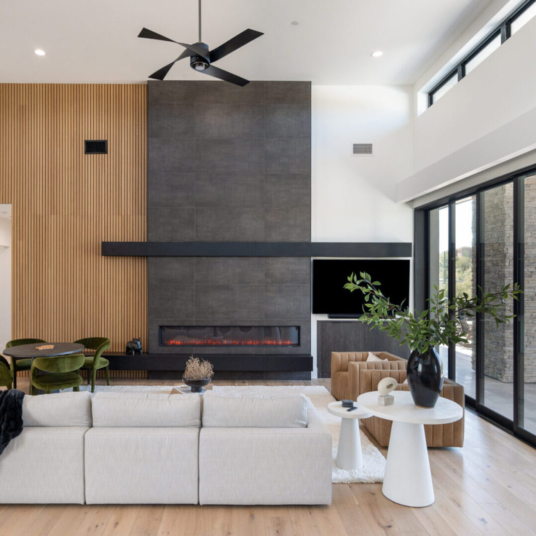 A living room with a fireplace and sliding glass doors.