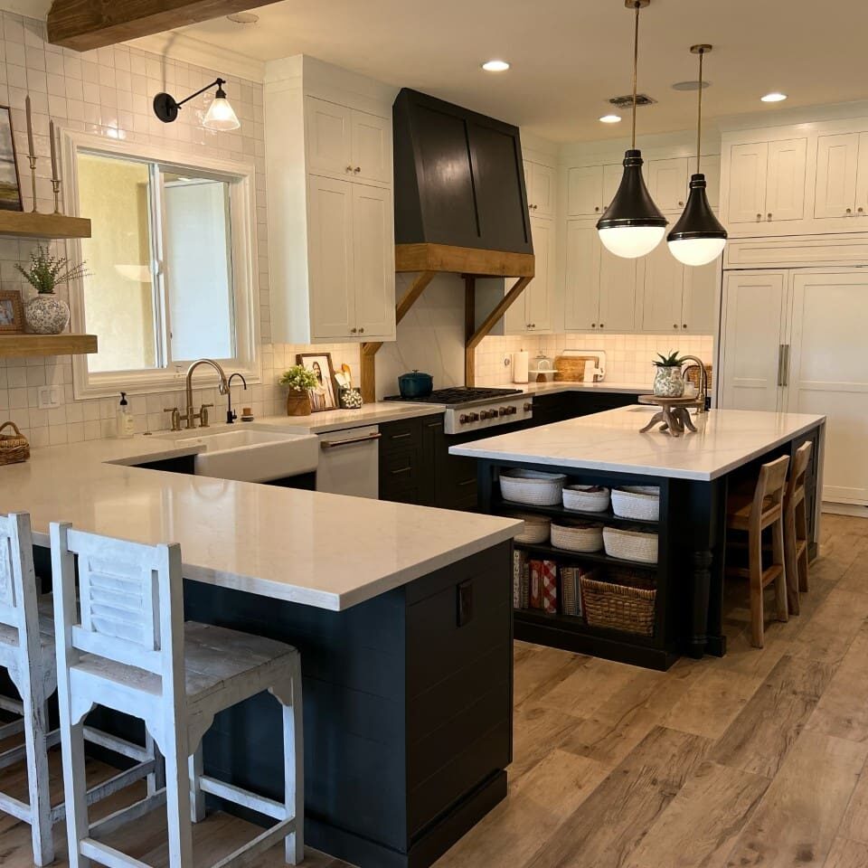 A kitchen with two different counters and one island.