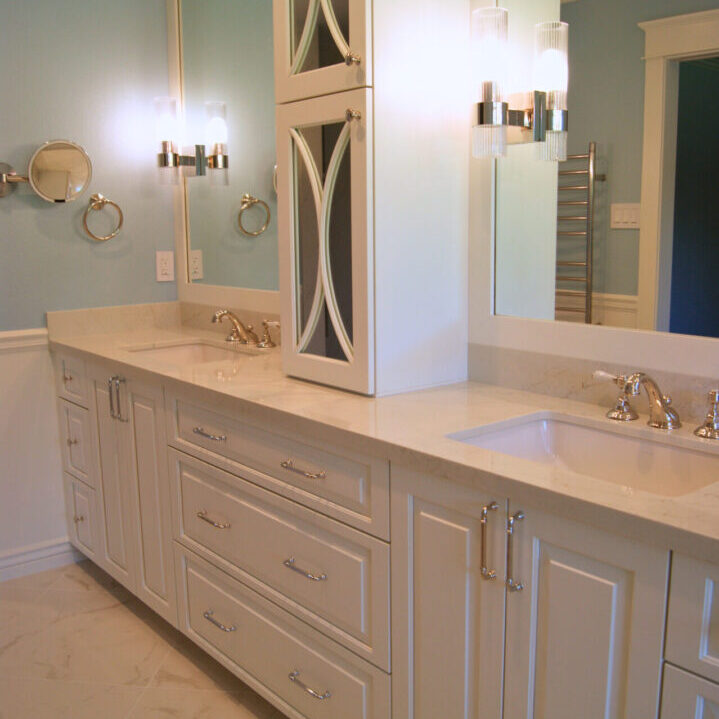 A bathroom with two sinks and a large mirror.