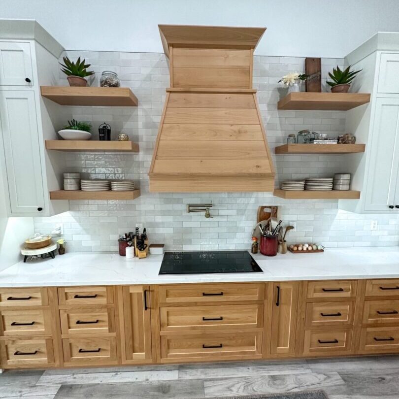 A kitchen with wooden cabinets and white counters.